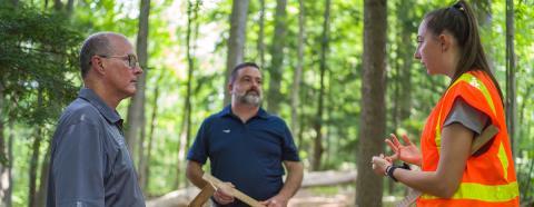 woman talking with two men about forest inventory